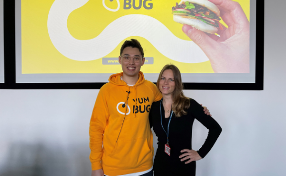 CEO Leo Taylor poses for a photo with Dr Klara Scheurenbrand in front of his Yum Bug presentation in the lecture theatre